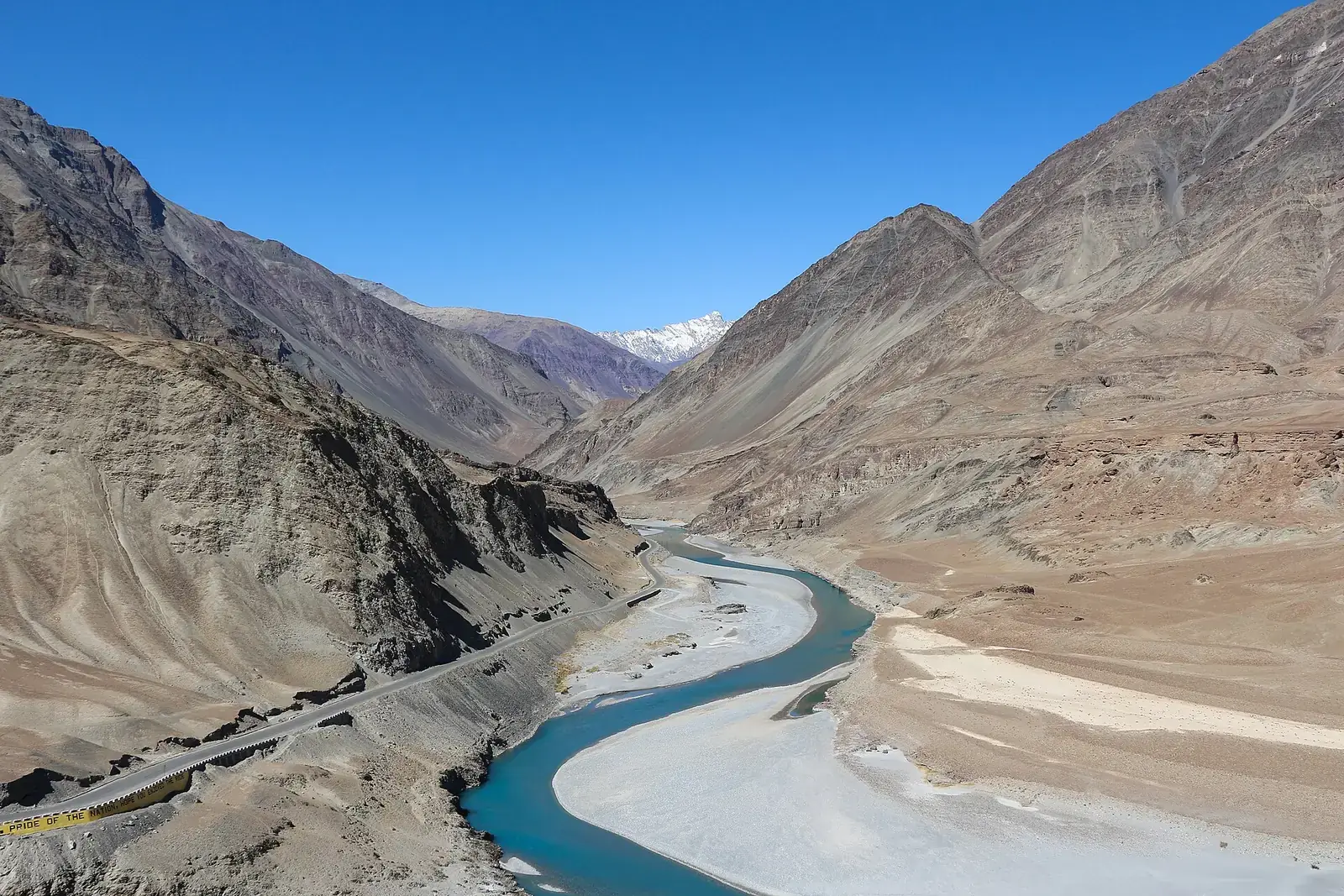 The turquoise Zanskar river winding through a Ladakh gorge