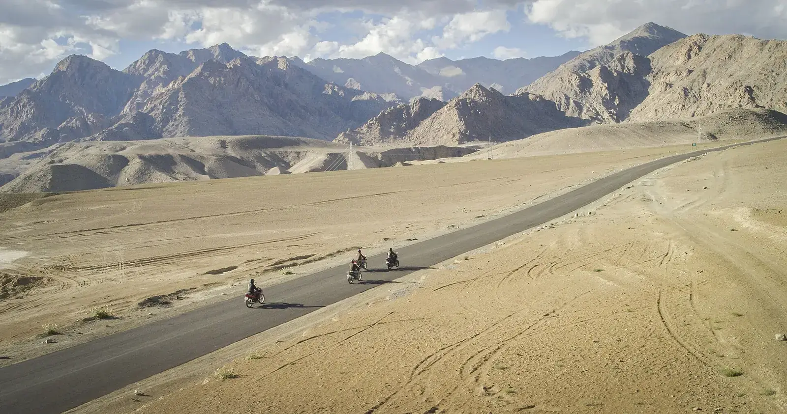 Motorcyclists on a desert road in Ladakh