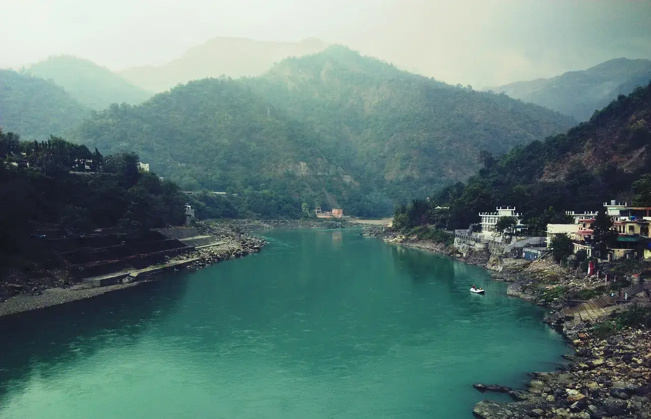 The Ganga flowing between green hills at Rishikesh