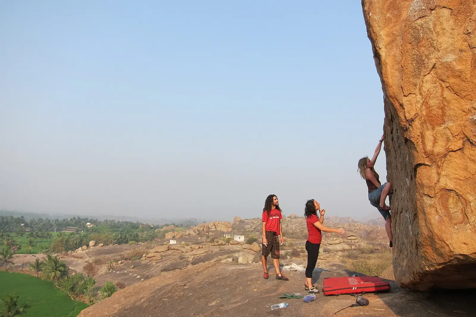 A climber bouldering on a granite boulder at Hampi