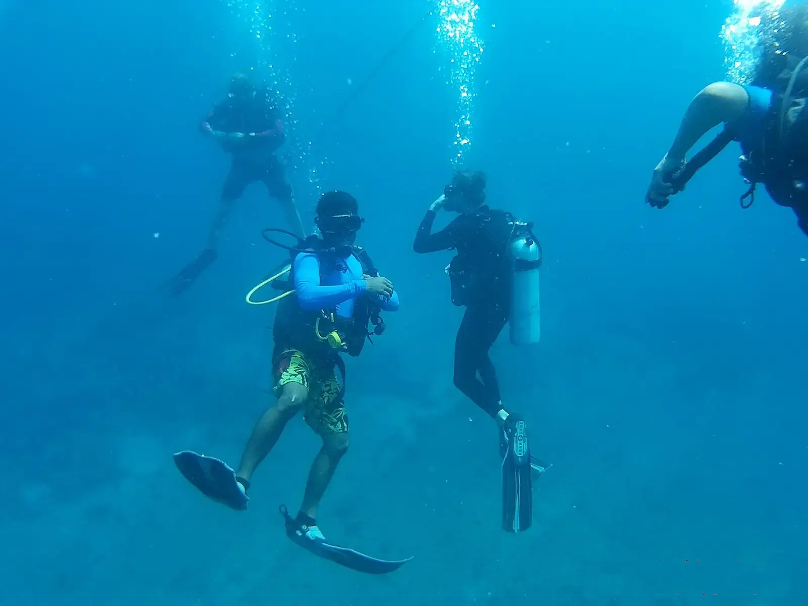 Scuba divers in blue water in the Andaman Islands