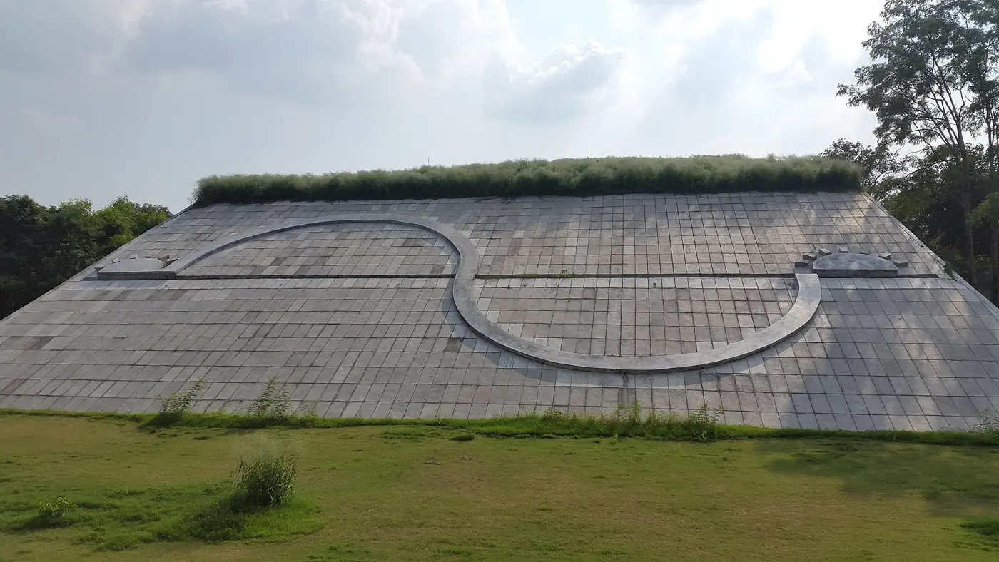 The Geometric Hill's sloped, tiled earthwork mound with its curved inlaid pathway at Capitol Complex, Chandigarh