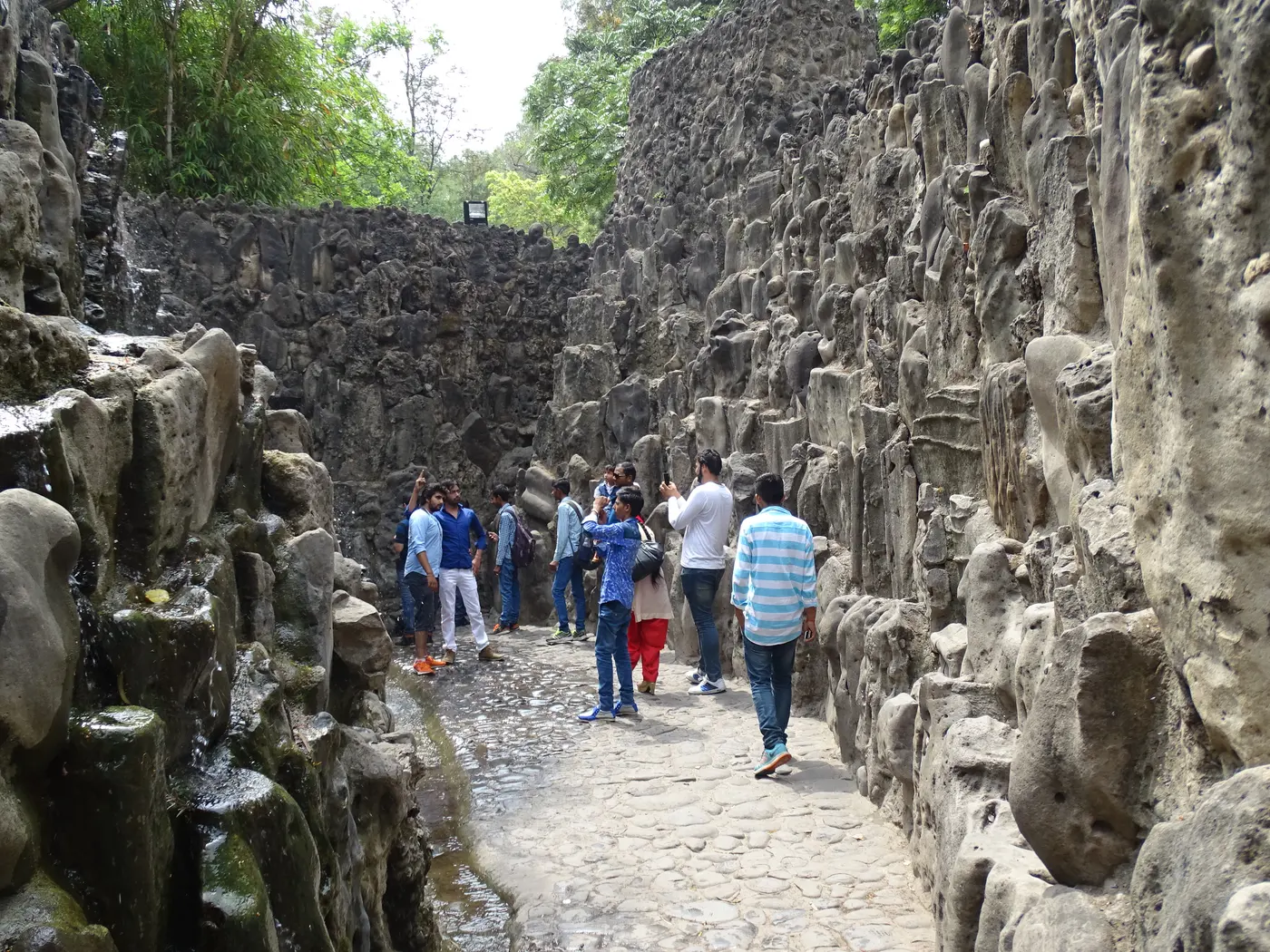 Narrow passage lined with stone walls in the Rock Garden, Chandigarh