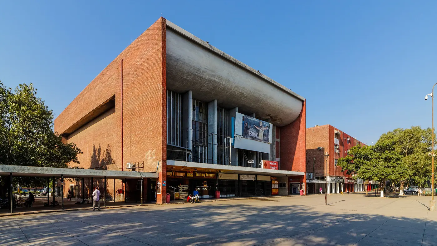 The brick and concrete facade of Neelam Theatre, Chandigarh's well-known old single-screen cinema in Sector 17