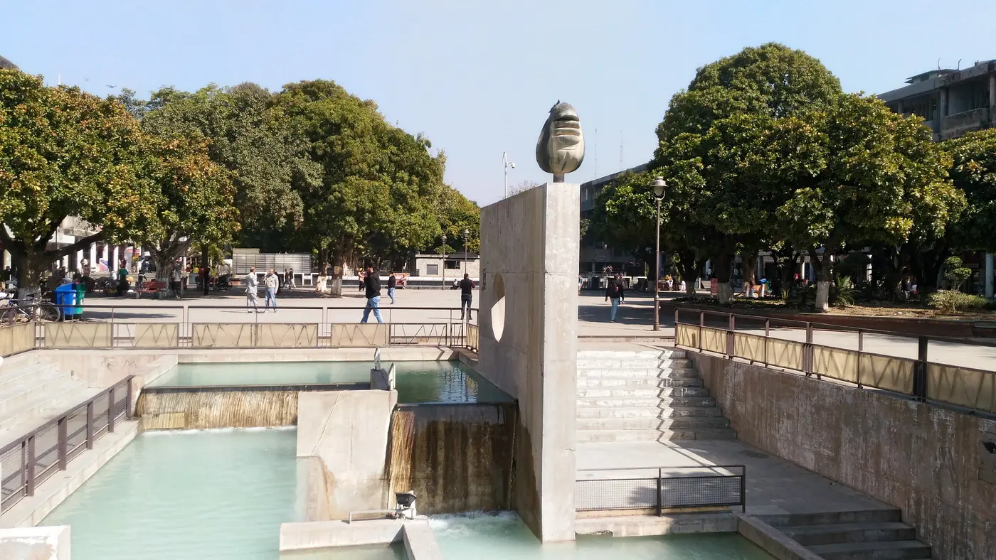 A stepped water-cascade sculpture and sunken pool in Sector 17 Plaza's pedestrian courtyard, Chandigarh