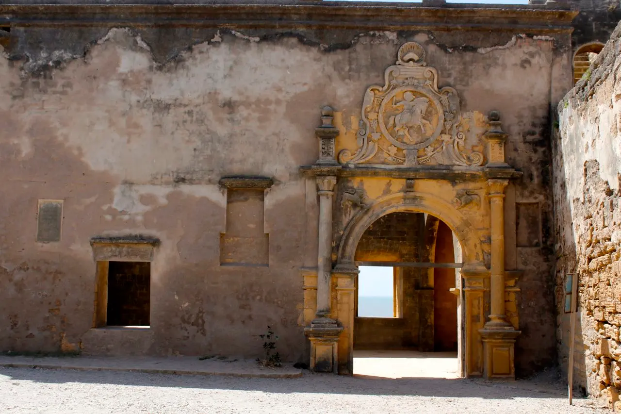 Ornate carved stone doorway of the old chapel inside Diu Fort's inner courtyard
