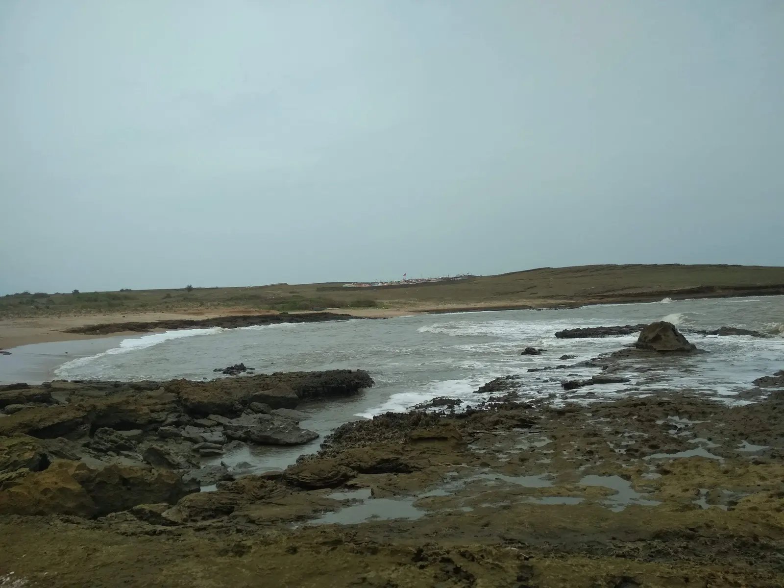 Rocky tidal coastline near Ghoghla Beach, Diu, where the sand gives way to exposed rock