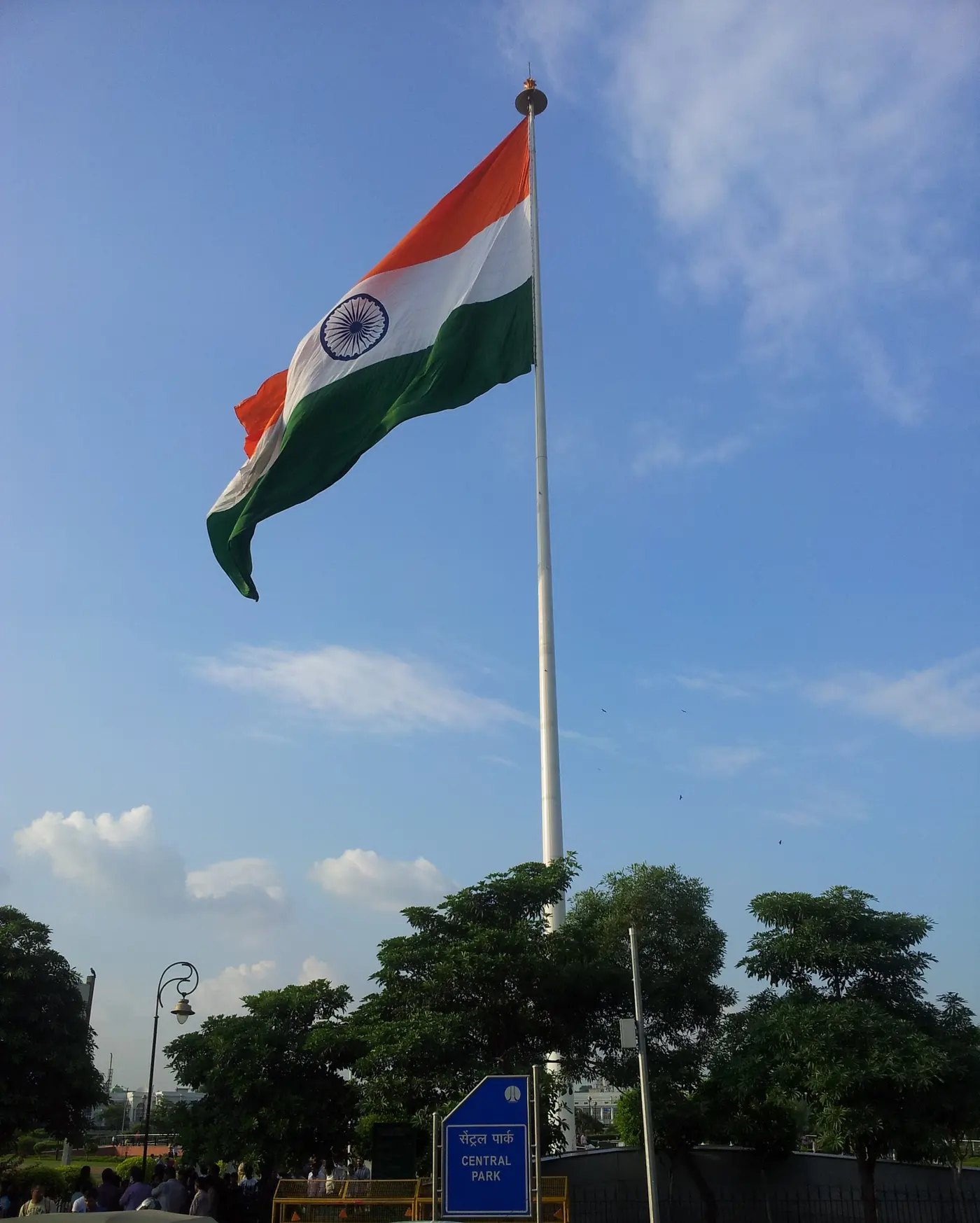 The large Indian National Flag flying above Central Park at Connaught Place, one of the tallest flagpoles in the country