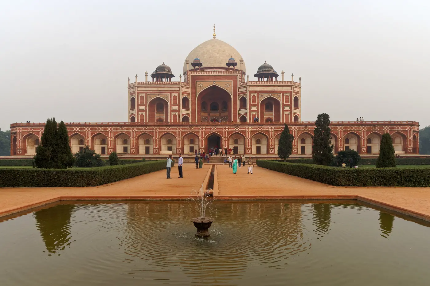 Humayun's Tomb, a red sandstone and white marble Mughal mausoleum, seen across its char-bagh garden and reflecting pool