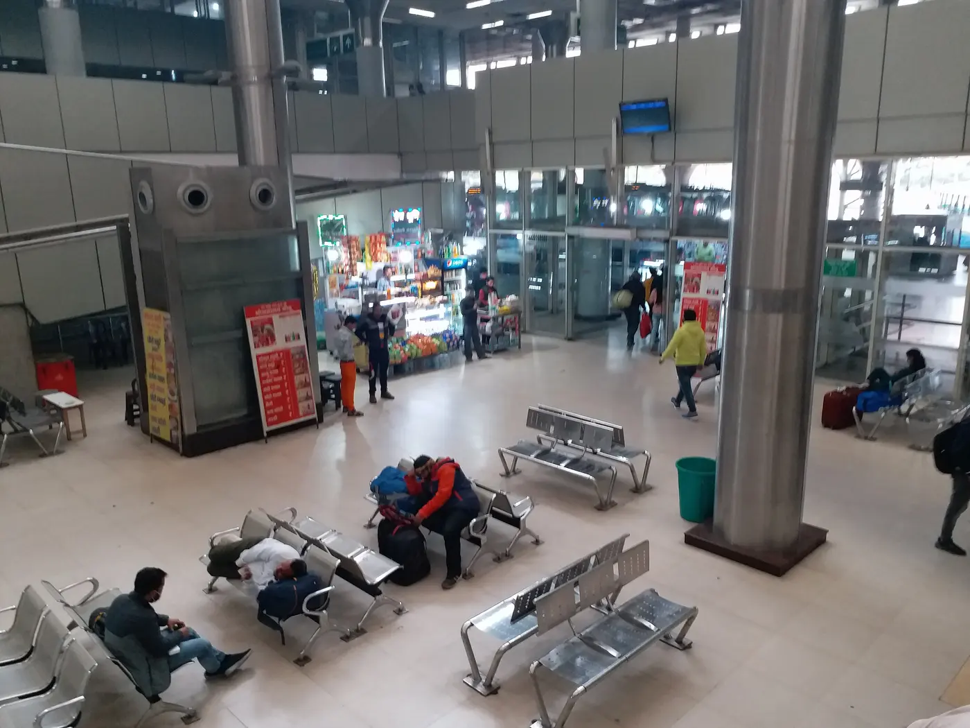 The waiting hall inside Kashmere Gate ISBT, Delhi's largest interstate bus terminal, with travellers and their luggage