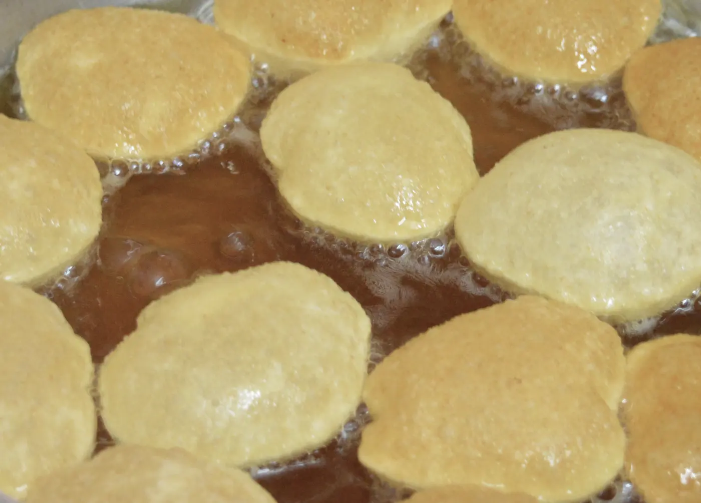Golgappe frying in hot oil at a street-side chaat stall, a staple of Laxmi Nagar's evening food scene