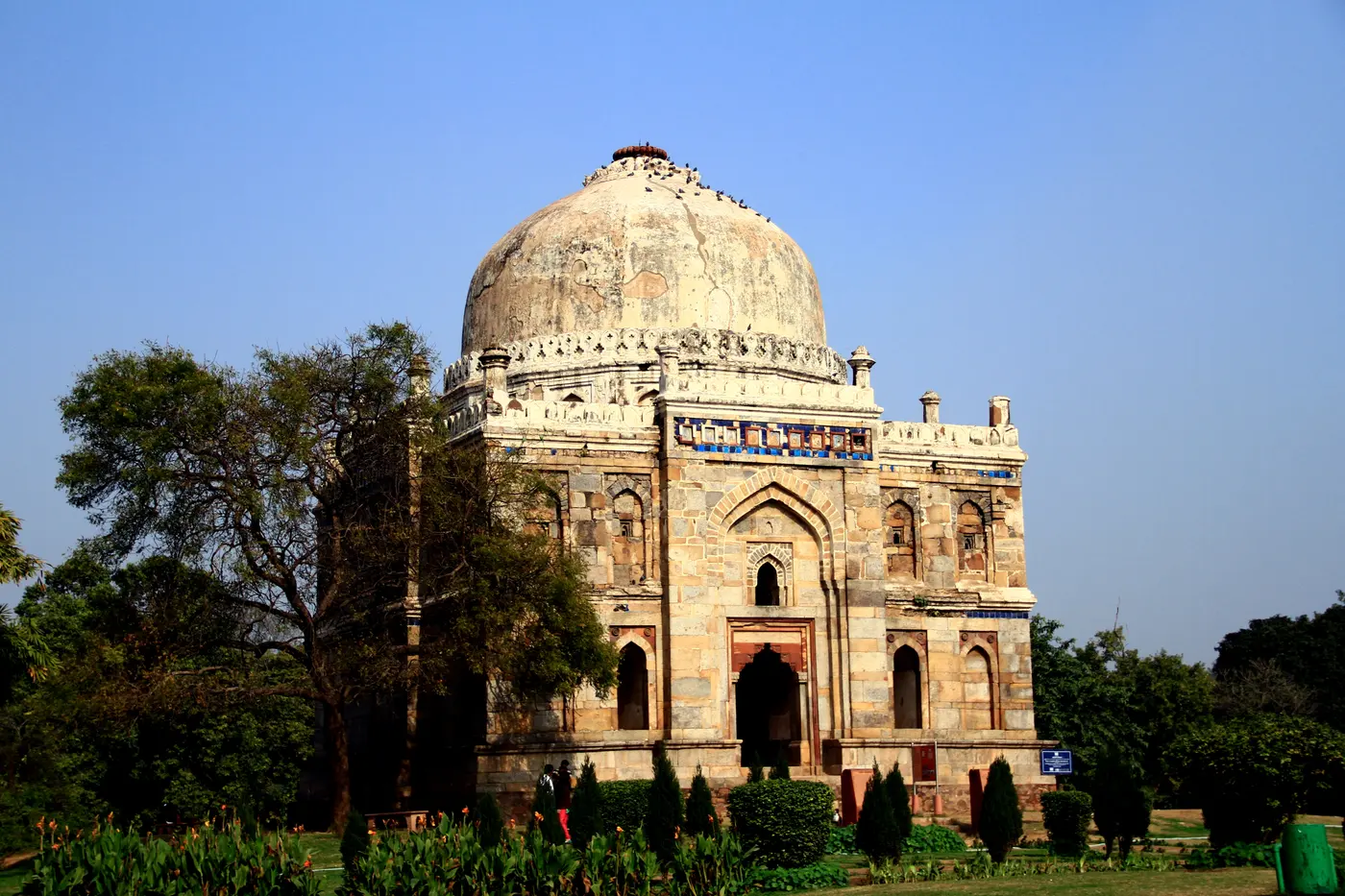 Sheesh Gumbad's domed facade in Lodhi Garden, still showing traces of its original blue and turquoise glazed tilework
