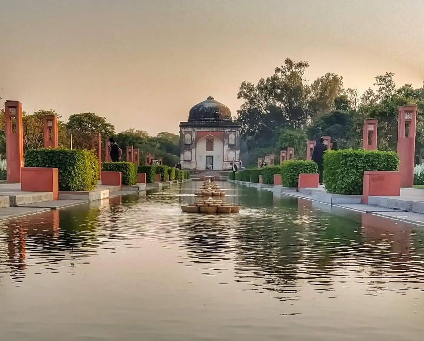 Landscaped lawns and restored Mughal-era monuments within Sunder Nursery heritage park, Delhi