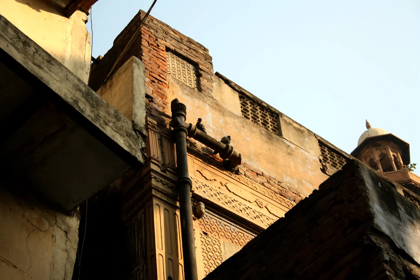 A narrow Paharganj lane lined with old multi-storey buildings housing budget guesthouses and shops