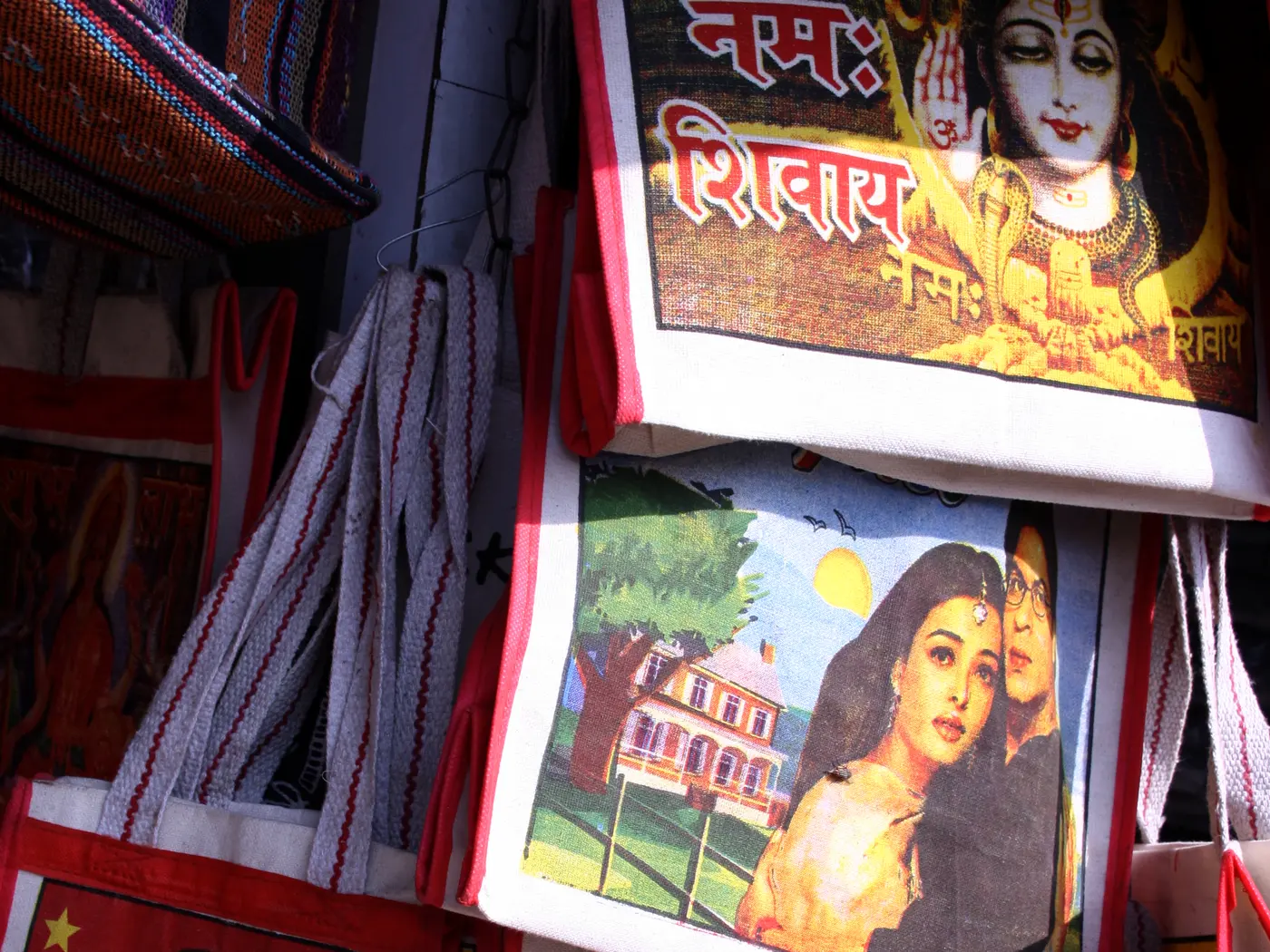 A bags and luggage shop stall on Paharganj's Main Bazaar, stacked with backpacks and duffel bags