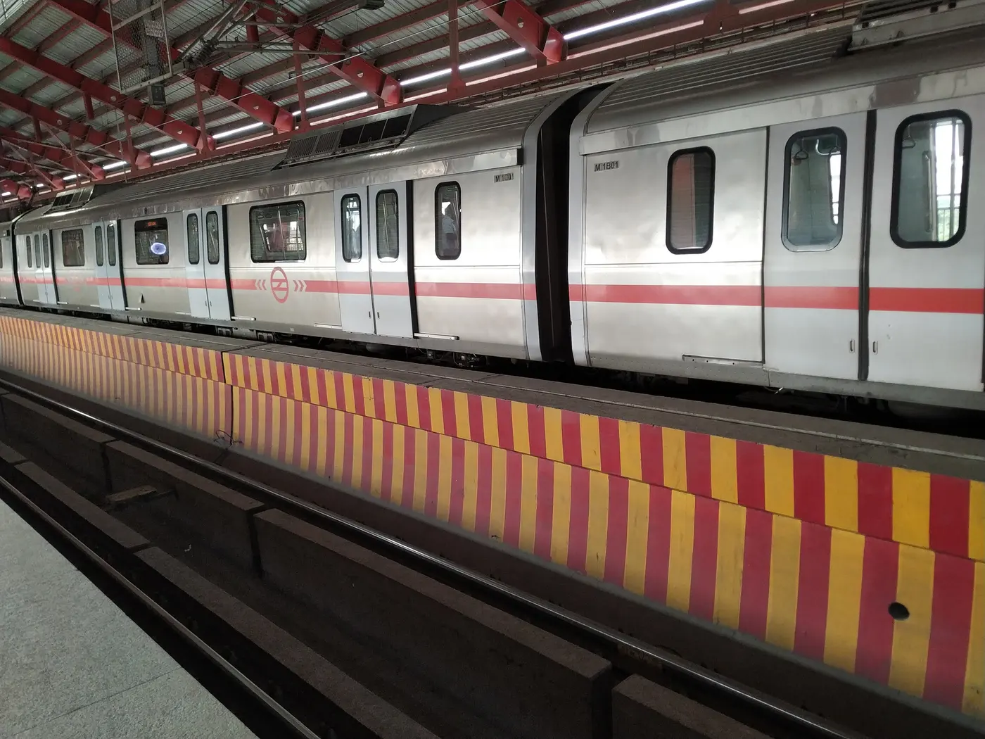 A Delhi Metro Red Line train at a platform, the line that serves Rohini West, Rohini East and Rithala stations