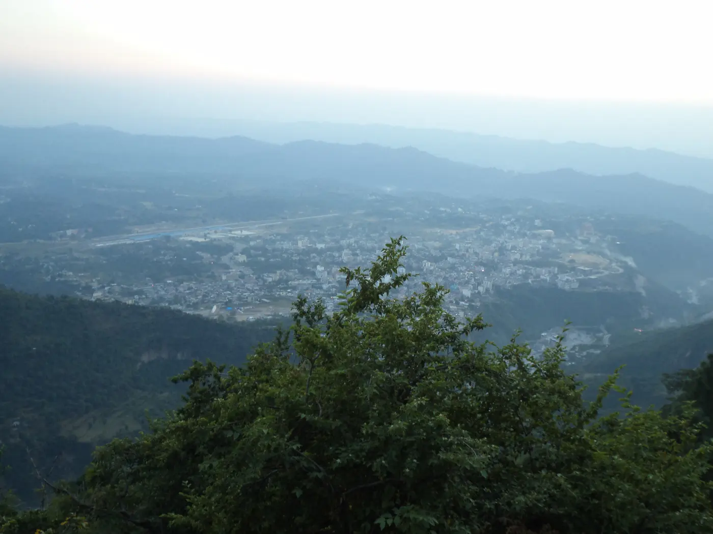 Aerial view of Katra town spread across the valley floor beneath the forested Trikuta Hills