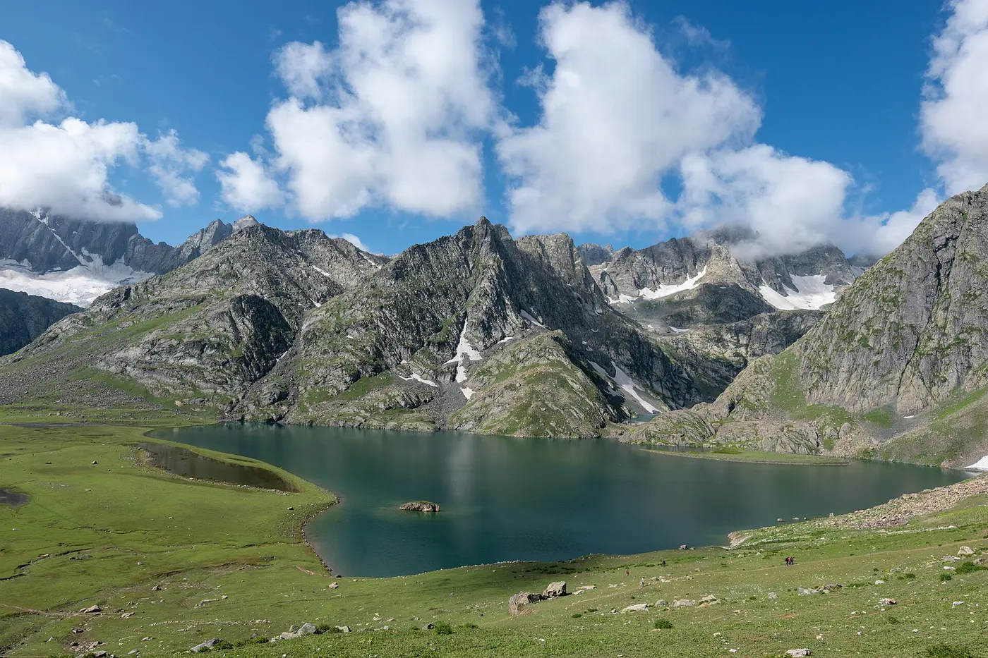 Krishansar Lake surrounded by rocky Himalayan peaks, an early stop on the multi-day Kashmir Great Lakes Trek from Sonamarg