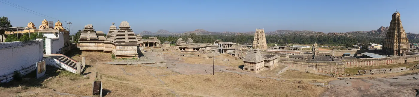 Panoramic view from Hemakuta Hill over Hampi's pre-Vijayanagara temple cluster toward the Virupaksha gopuram