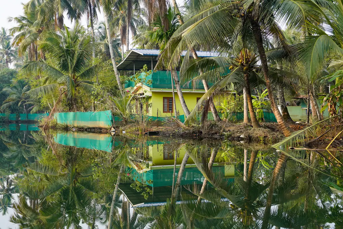Narrow canal through a village on Munroe Island