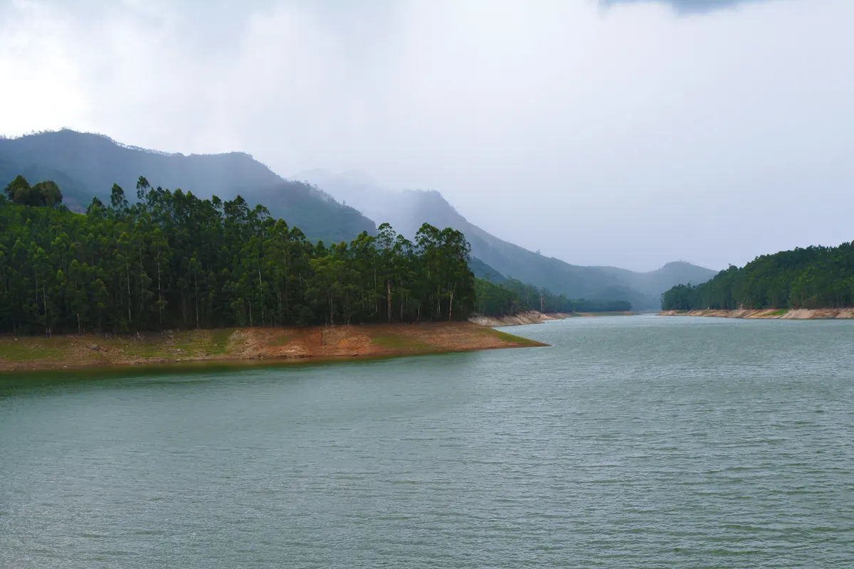 Mattupetty Dam reservoir surrounded by forested hills near Munnar