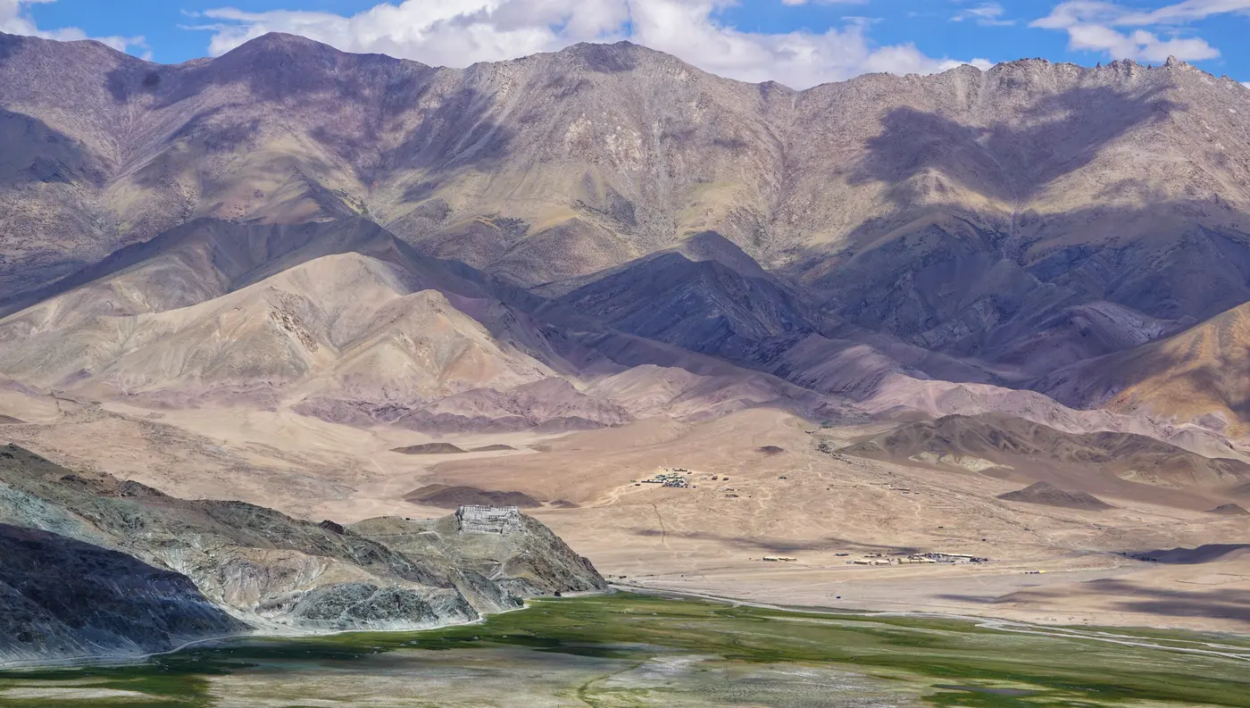 Hanle Monastery on its hillock above the green marshland of the Hanle valley, Changthang plateau
