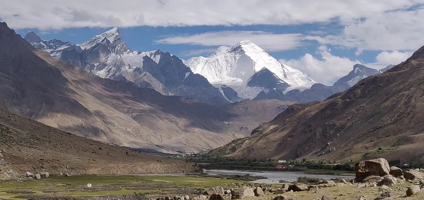 The snow-capped twin peaks of the Nun Kun massif rising above the green Suru Valley near Panikhar