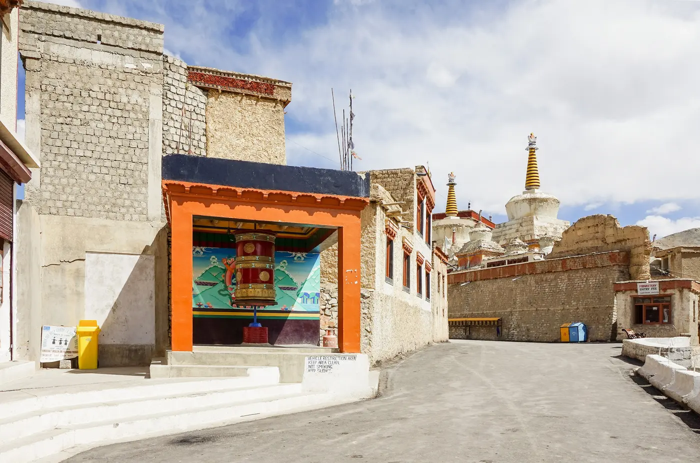 The entrance courtyard of Lamayuru Monastery strung with prayer flags, Ladakh