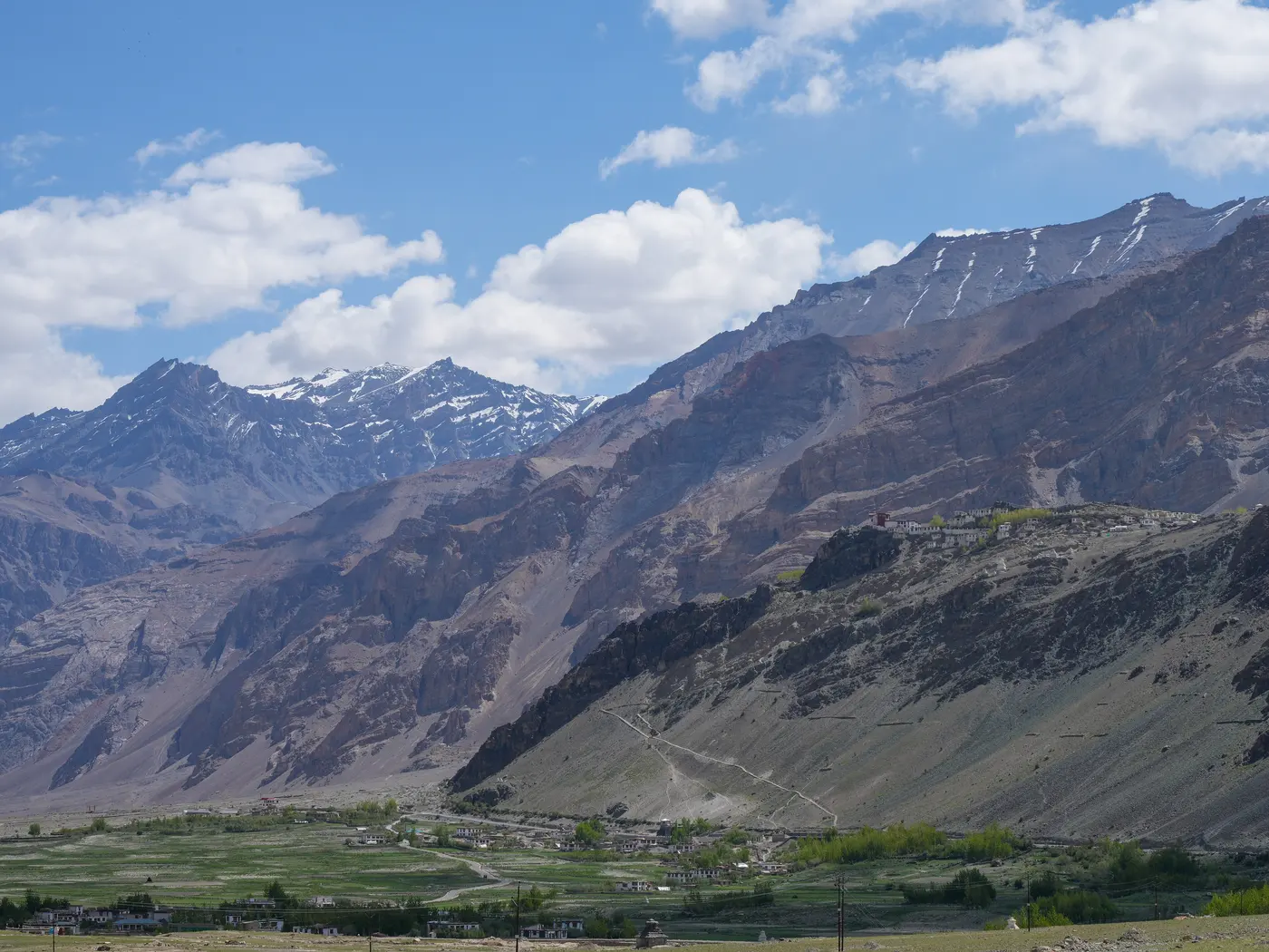 Stongdey Monastery's buildings stacked on a high spur above the Zanskar valley, seen from across the valley floor