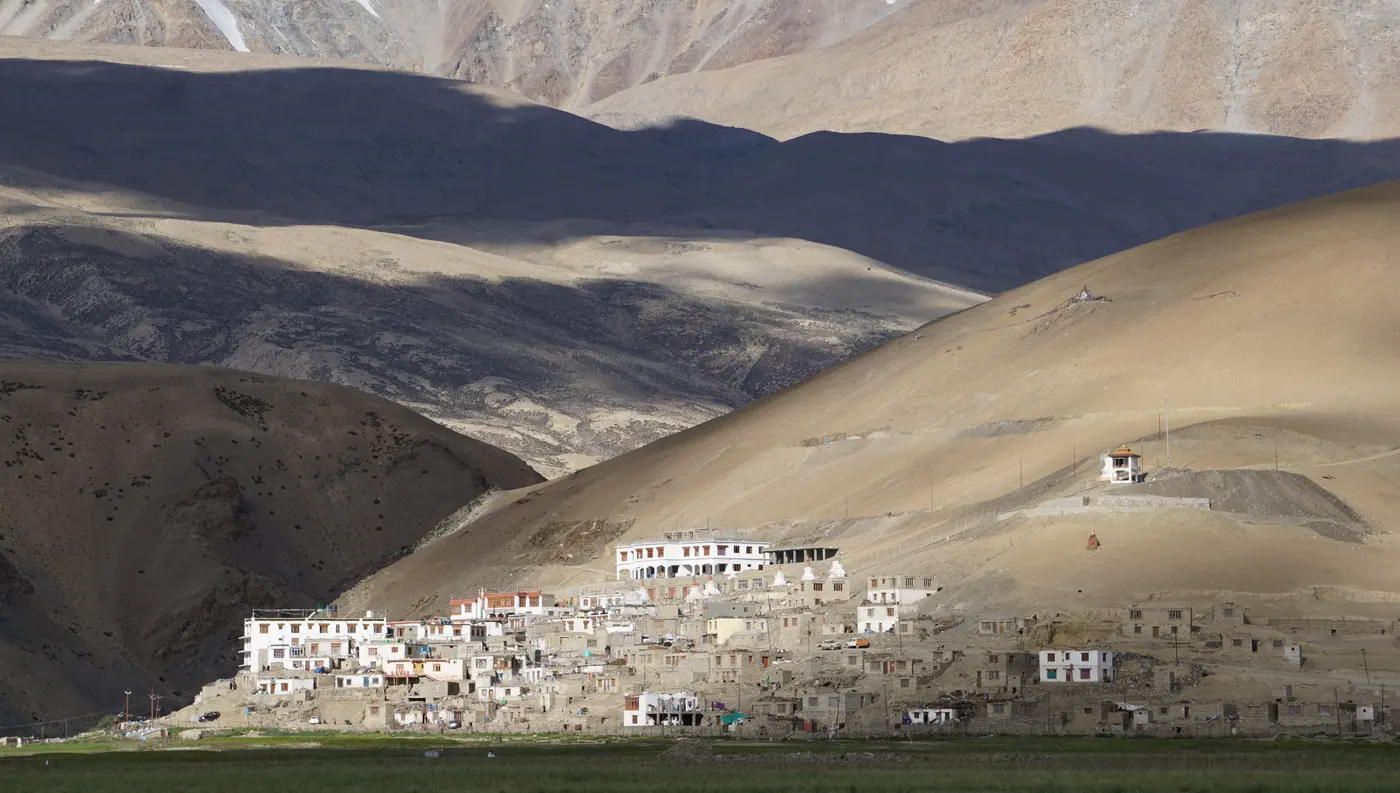 Korzok village and its Drukpa Kagyu monastery set against the bare Rupshu mountains on Tso Moriri's shore