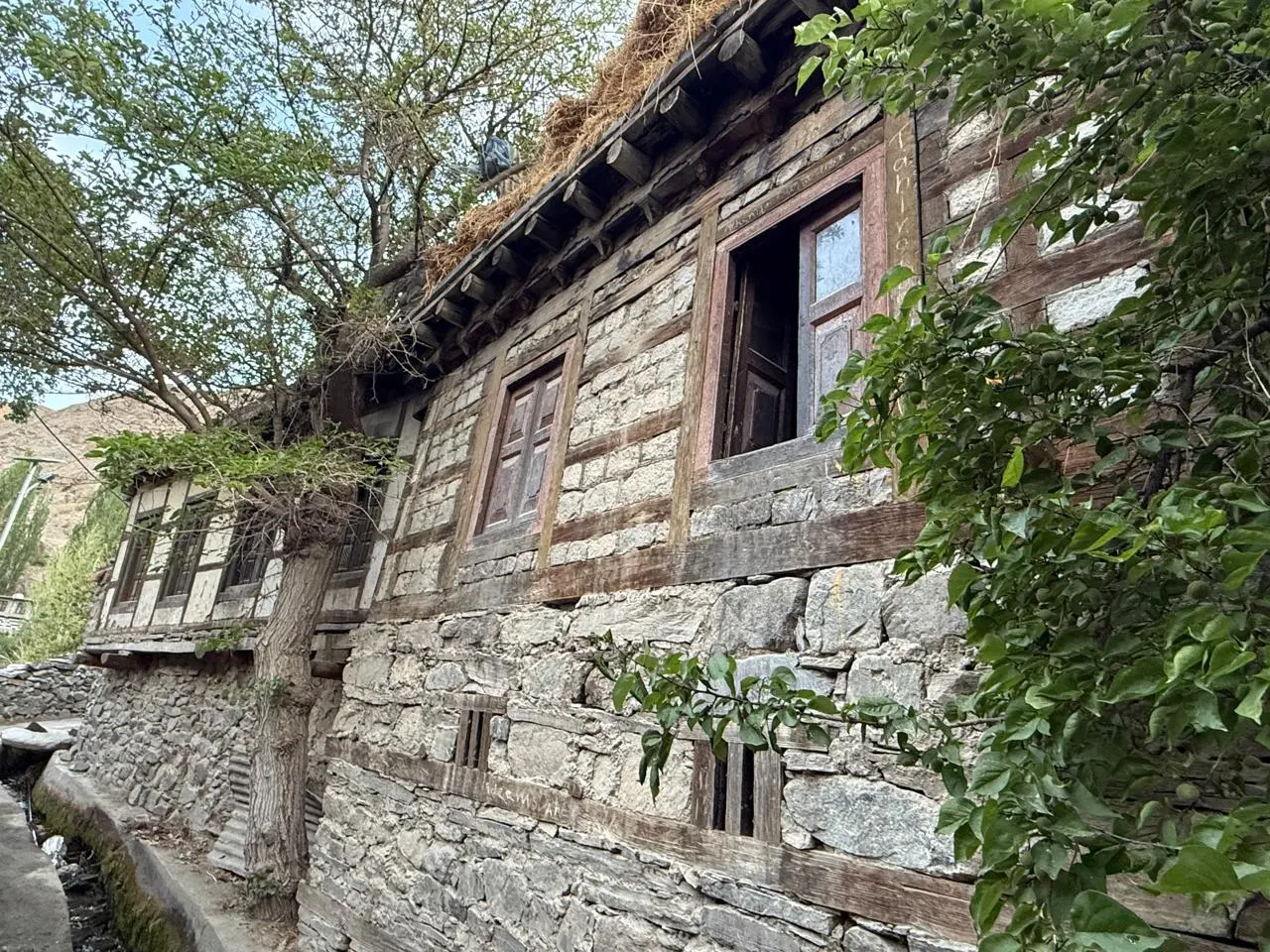 Traditional Balti stone-and-timber house with carved wooden window frames in Tyakshi Grong, near Turtuk