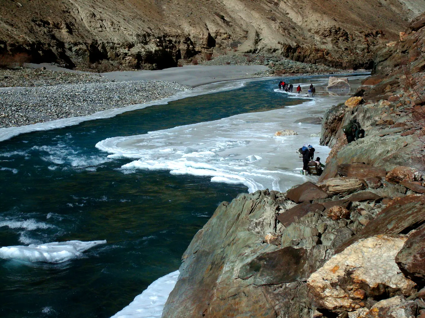 Trekkers walking on the frozen Zanskar river on the Chadar trek