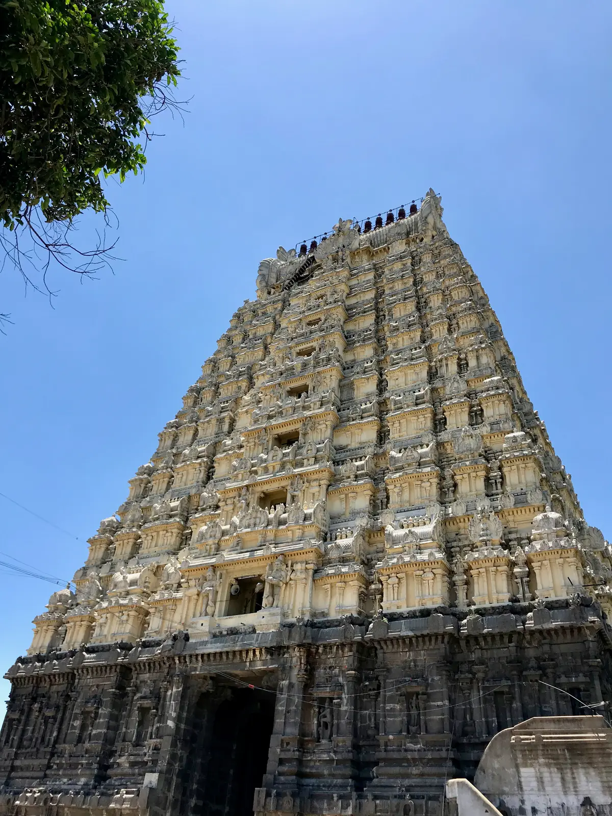 The towering stone gopuram of Ekambareswarar Temple, Kanchipuram, rising against a clear blue sky