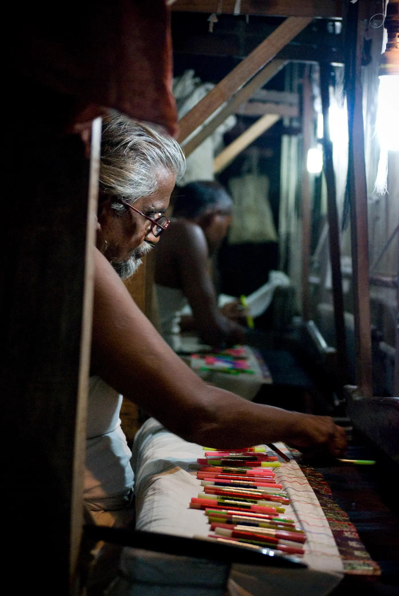 Weaver at a handloom making a Banarasi silk saree