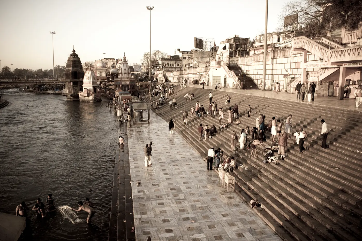 Sunrise view over the main bathing ghat steps at Har Ki Pauri, Haridwar, with pilgrims along the Ganga