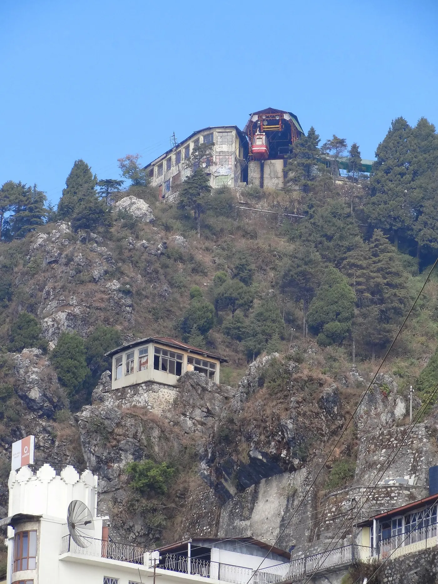 The red cable car and upper ropeway station perched on the rocky summit of Gun Hill, Mussoorie