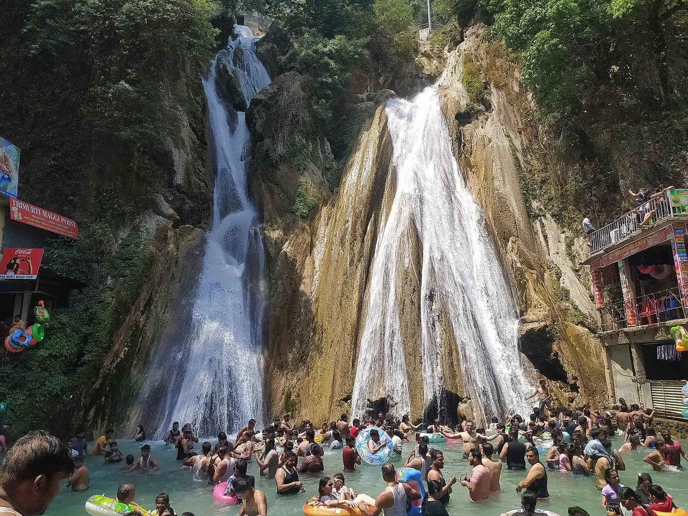 Crowds wading in the pools beneath the multi-tiered Kempty Falls near Mussoorie