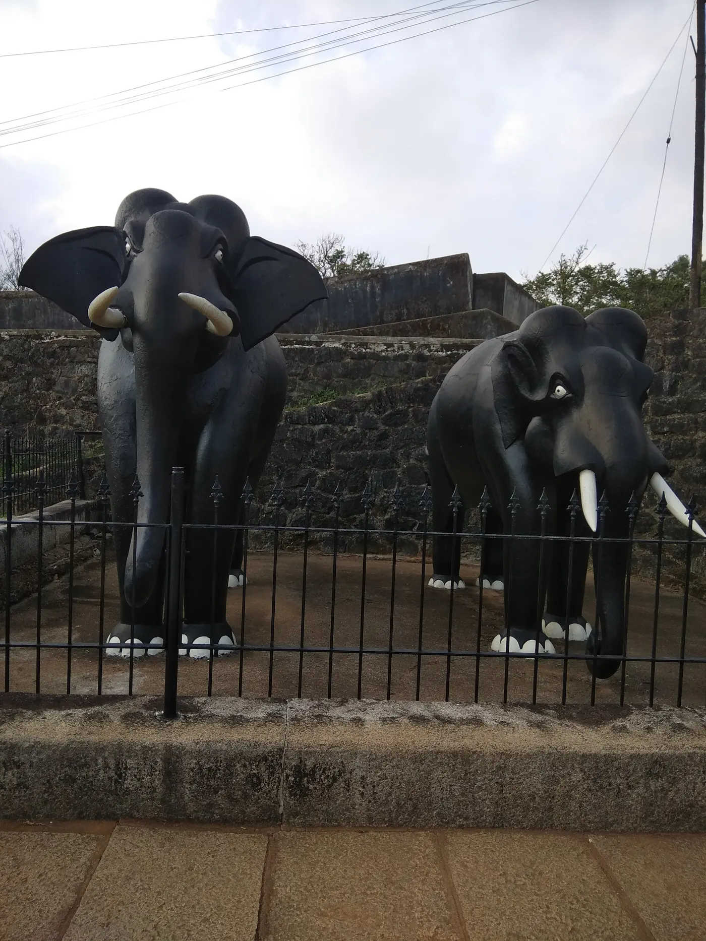 Life-size elephant statues at the main gate of Madikeri Fort