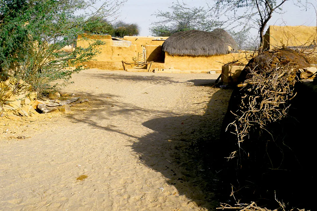 Traditional mud-and-thatch house in Khuri village on the edge of the Thar Desert dunes