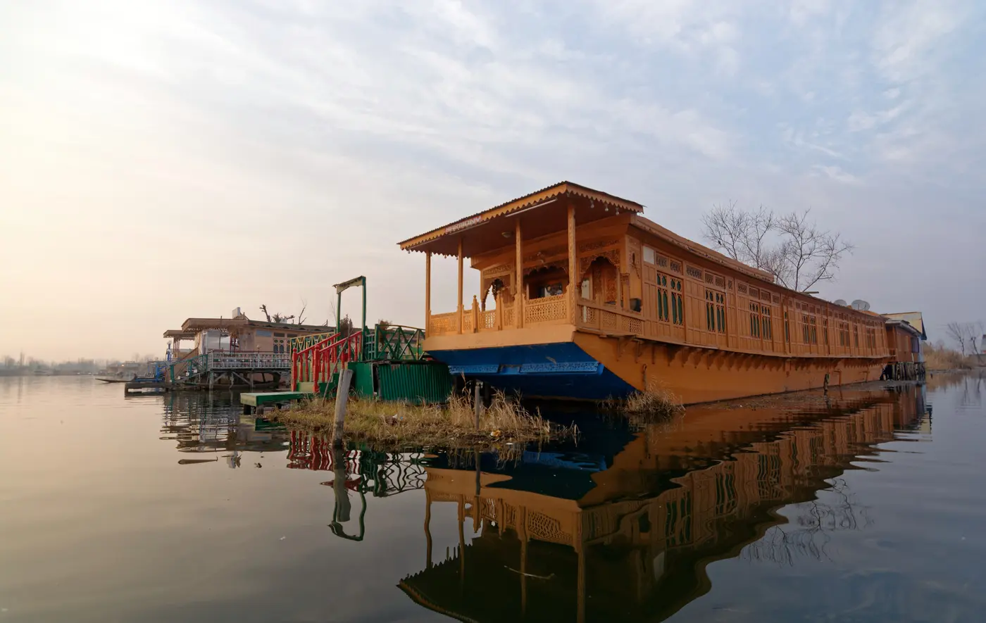 Carved wooden houseboat moored on Dal Lake, Srinagar