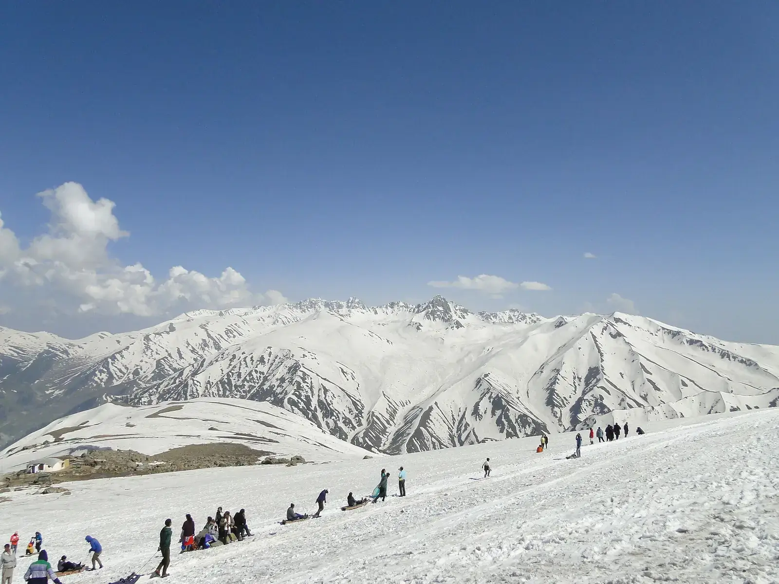 Snow-covered slopes and visitors at Gulmarg, Kashmir