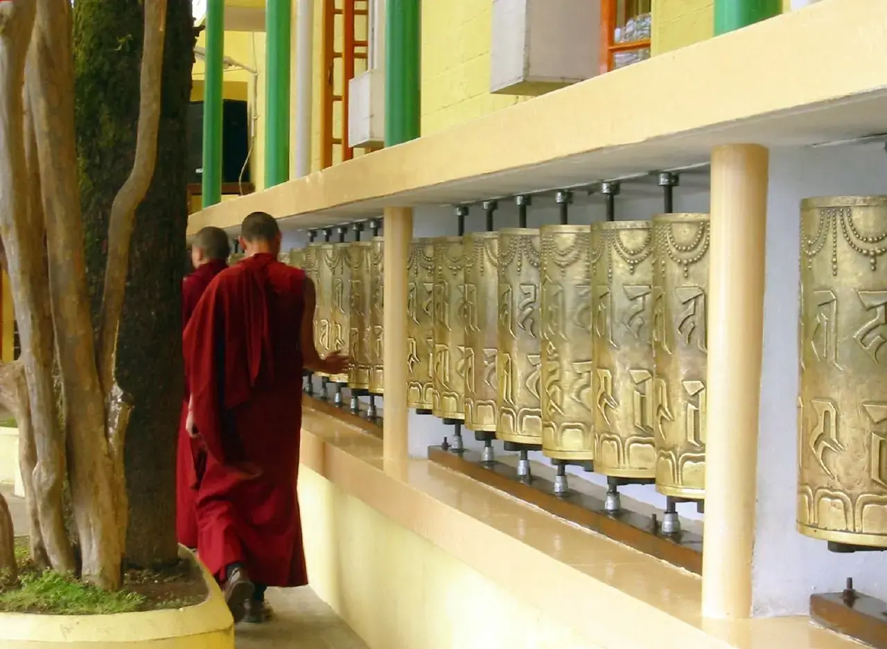 A monk turning prayer wheels at the Tsuglagkhang complex, McLeod Ganj