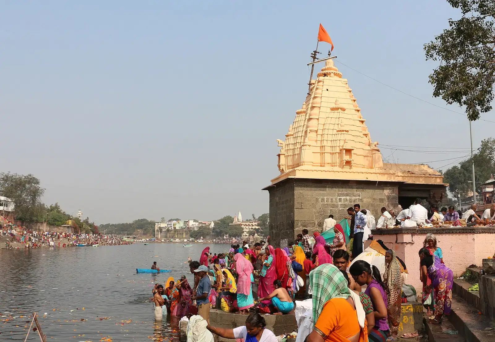 A temple and bathers at Shri Ram Ghat on the Shipra river, Ujjain